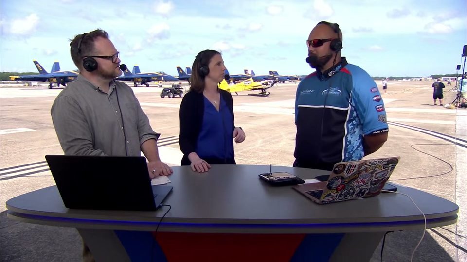 Broadcast anchor desk on the flightline with a guest performer